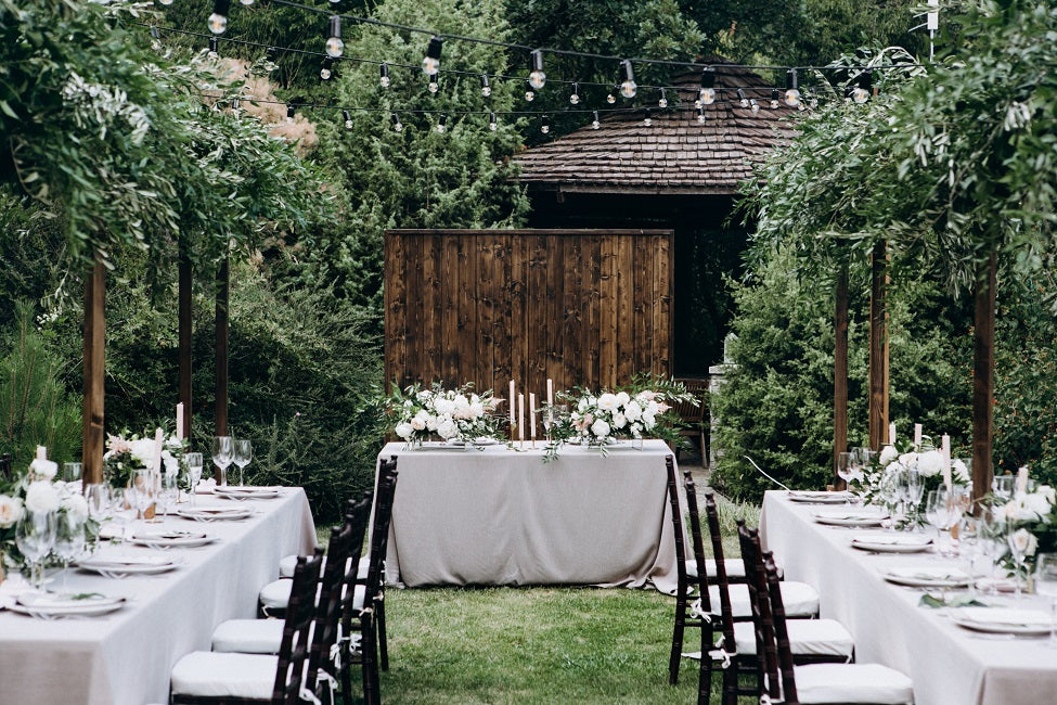 outdoor banquet with white polyester tablecloths