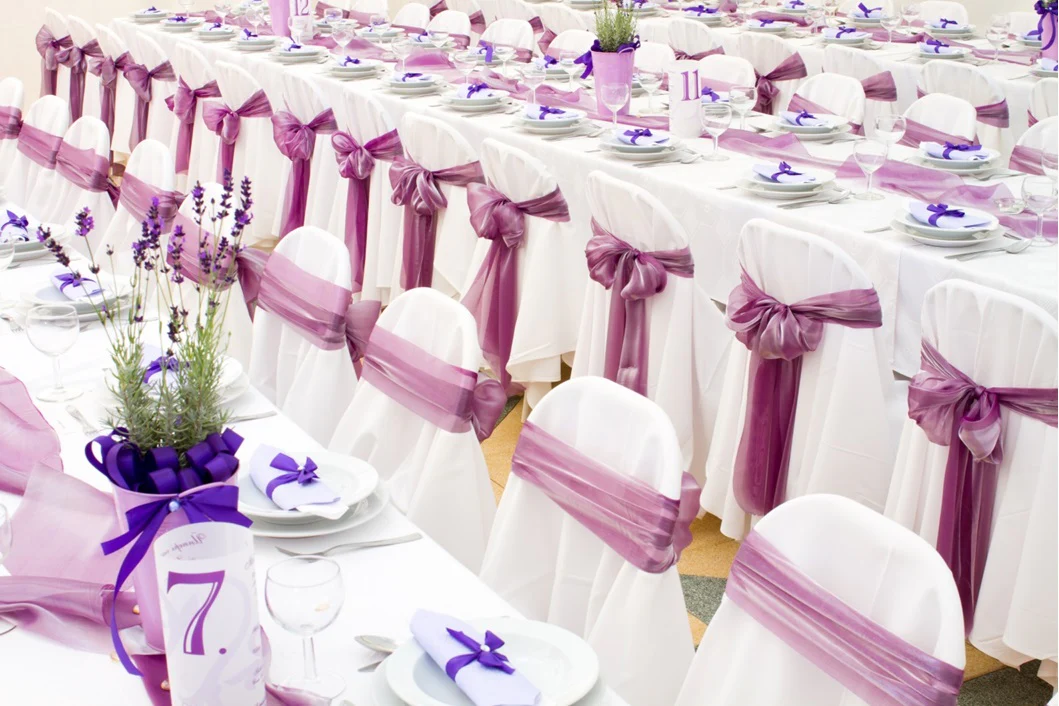 white banquet chair cover with purple organza sash