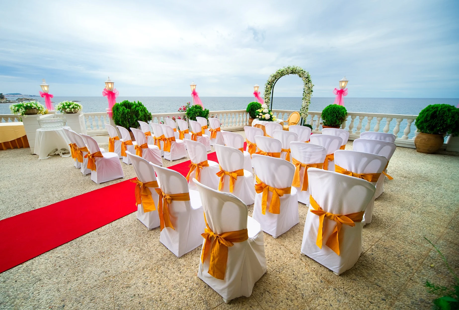 white banquet chair covers with organge chair sashes